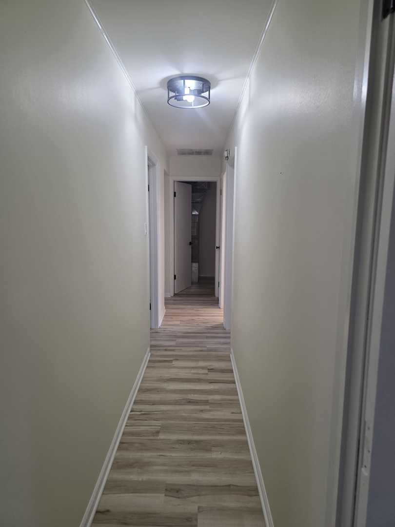 4905 143rd Place Midlothian, IL 60445 - Photo 11 of 17 a view of a hallway with wooden floor and staircase