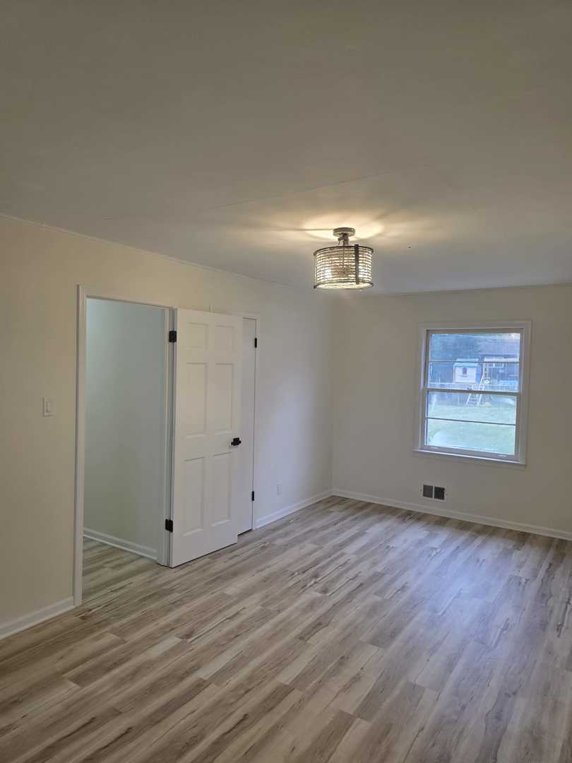 4905 143rd Place Midlothian, IL 60445 - Photo 12 of 17 a view of an empty room with wooden floor and a window