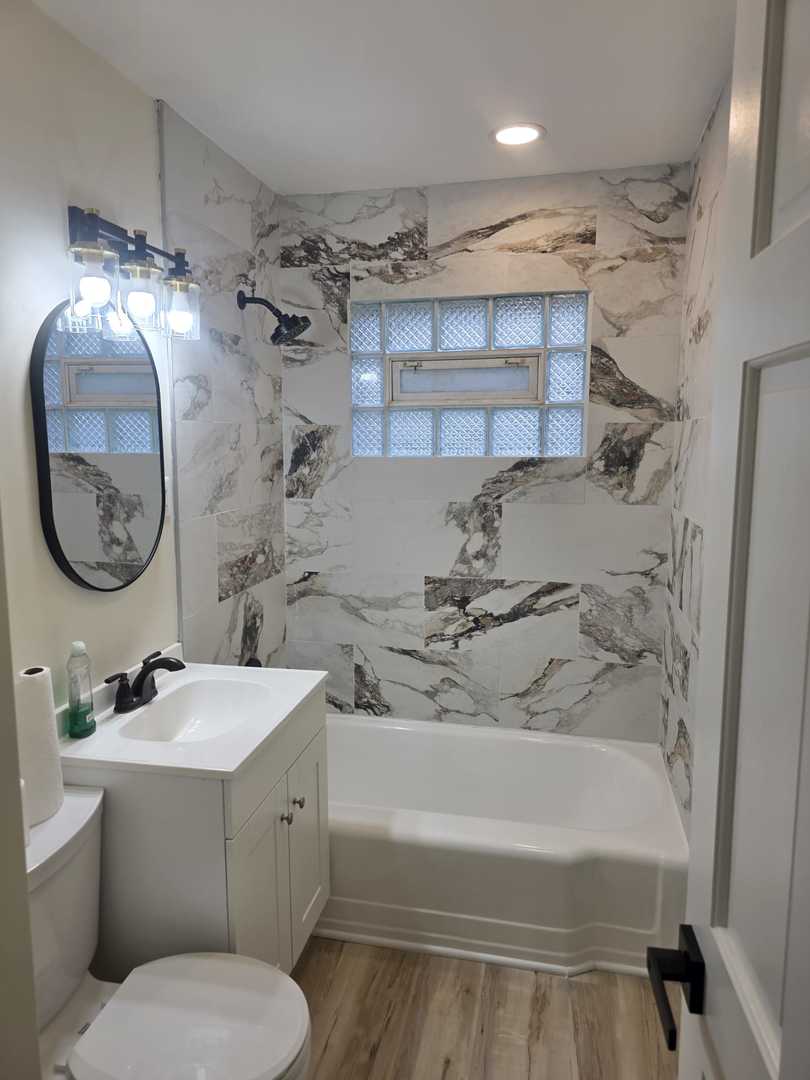 4905 143rd Place Midlothian, IL 60445 - Photo 8 of 17 a bathroom with a sink a toilet and a mirror