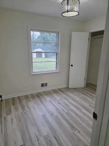 a view of a room with wooden floor