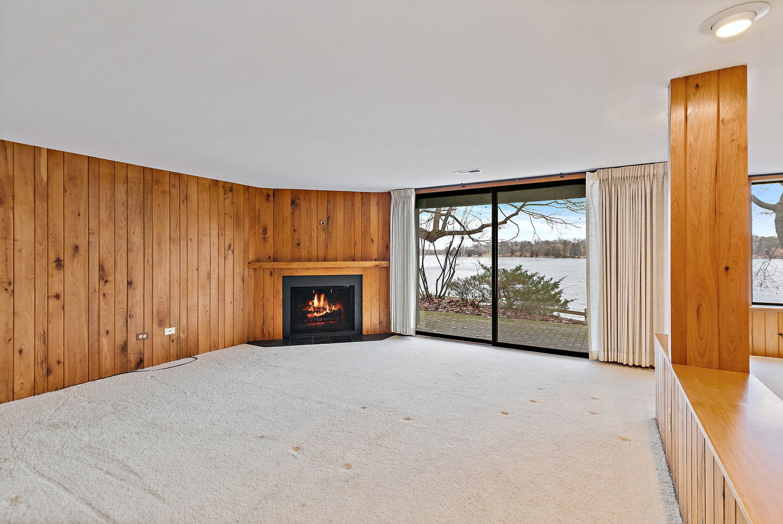 25 Shoreline Road, Unit D Lake Barrington, IL 60010 - Photo 23 of 43 a view of an empty room with a fireplace and a window