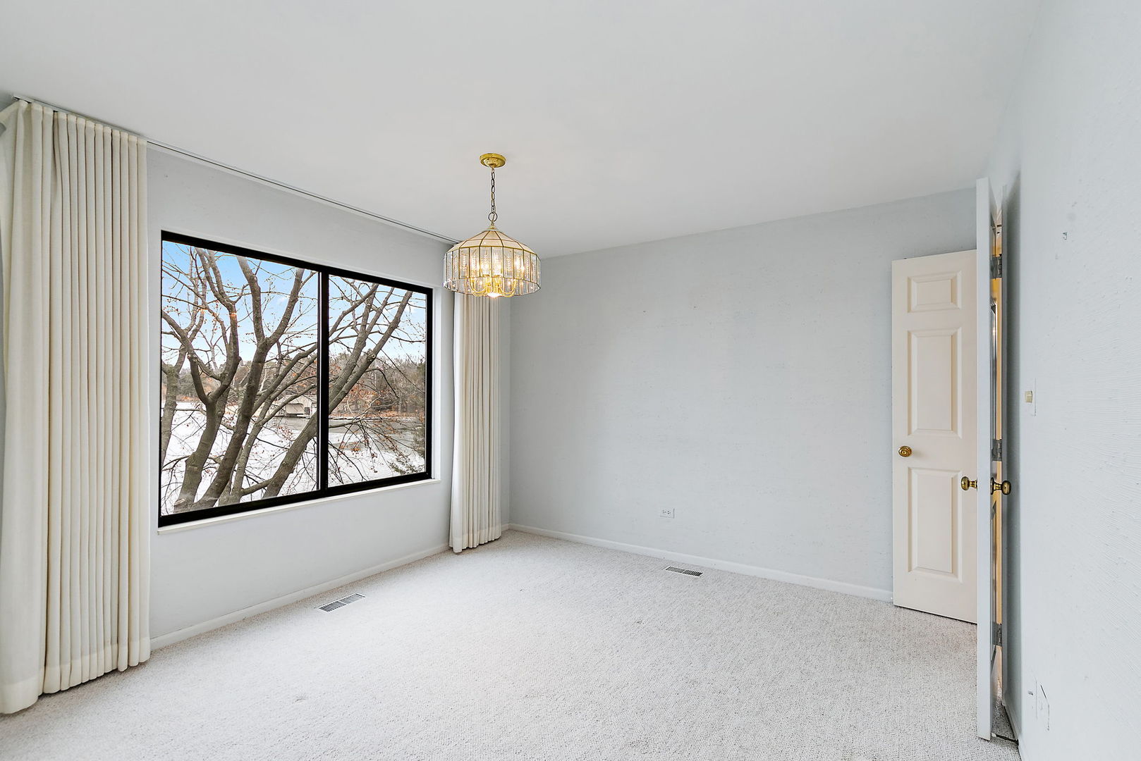 25 Shoreline Road, Unit D Lake Barrington, IL 60010 - Photo 8 of 43 a view of an empty room and a window