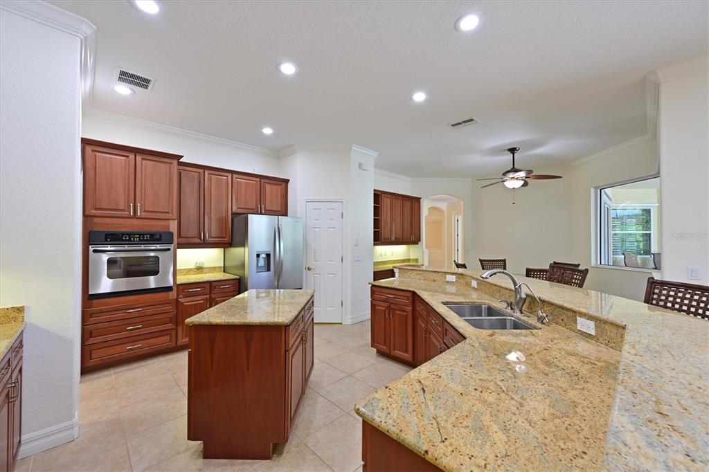 10622 Conch Shell Terrace Bradenton, FL 34212 - Photo 8 of 69 a large kitchen with stainless steel appliances granite countertop a sink stove and refrigerator