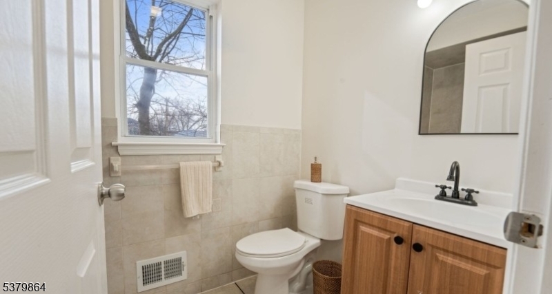 695 South 11th Street Newark, NJ 07103 - Photo 11 of 13 a bathroom with a toilet sink and mirror