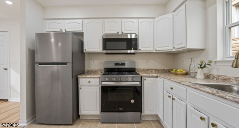 695 South 11th Street Newark, NJ 07103 - Photo 2 of 13 a kitchen with cabinets stainless steel appliances and a window