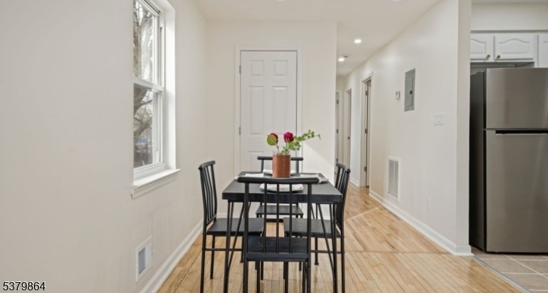 695 South 11th Street Newark, NJ 07103 - Photo 5 of 13 a view of a dining room with furniture wooden floor and a chandelier