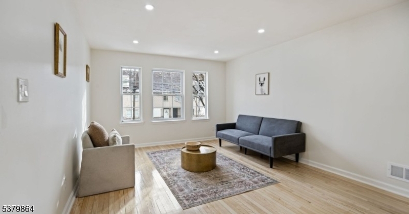 695 South 11th Street Newark, NJ 07103 - Photo 6 of 13 a living room with furniture and a window