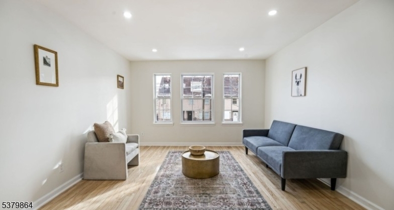 695 South 11th Street Newark, NJ 07103 - Photo 8 of 13 a living room with furniture and a window