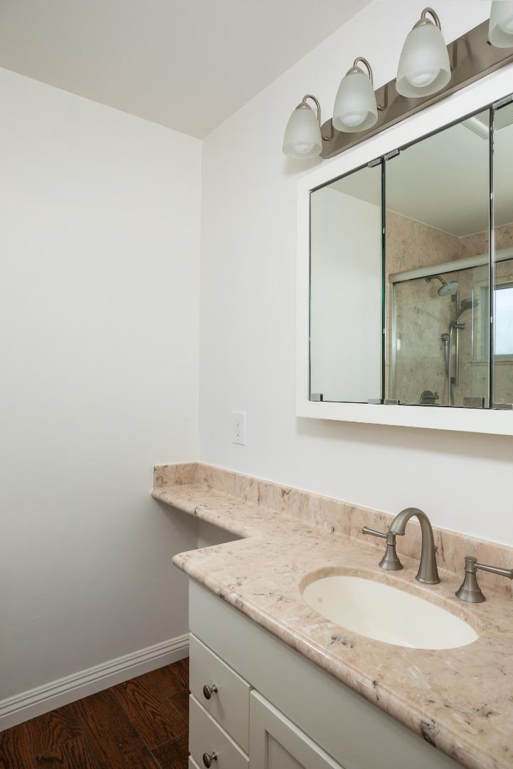 1937 Adelaide Way San Jose, CA 95124 - Photo 19 of 33 a bathroom with a granite countertop sink and a mirror