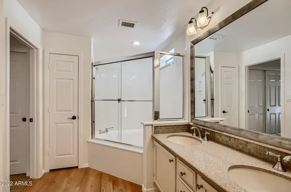 a bathroom with a granite countertop sink mirror and double