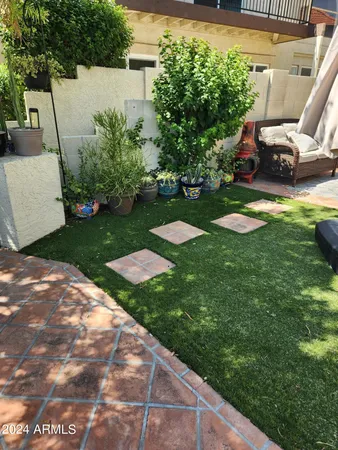 a view of a backyard with sitting area