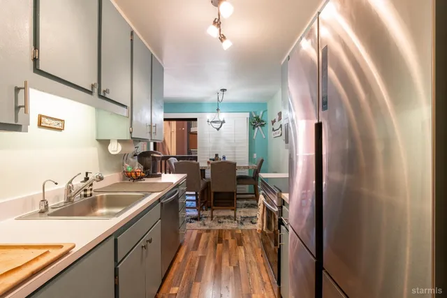 a kitchen with a sink appliances and cabinets