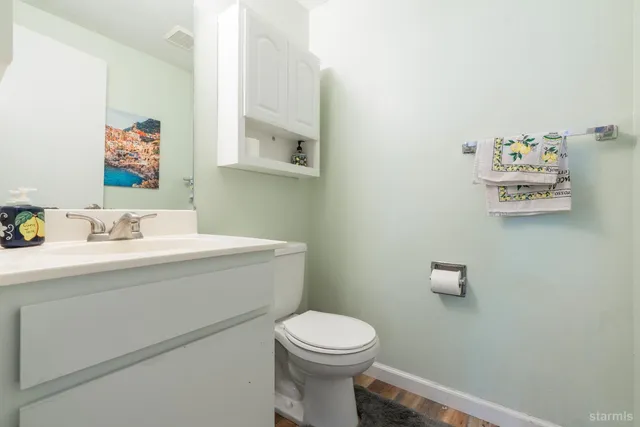 a bathroom with a sink mirror and toilet