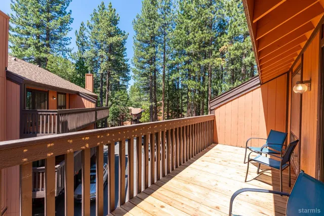 a view of a two chairs in the balcony