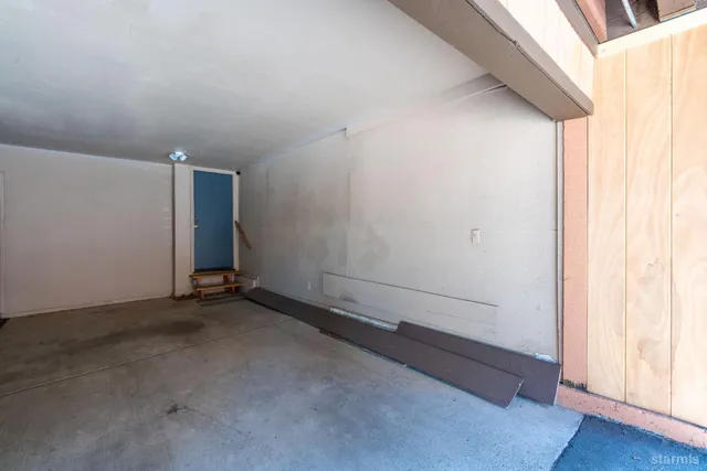 a view of balcony with wooden deck and furniture