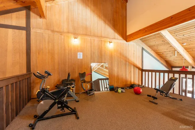 a living room with furniture pool table and window