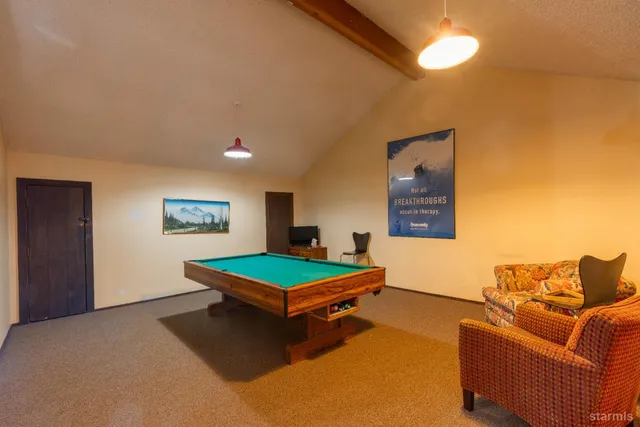 a dining room with furniture and a floor to ceiling window