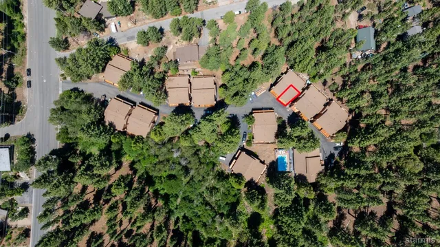 an aerial view of a house with a yard and outdoor space