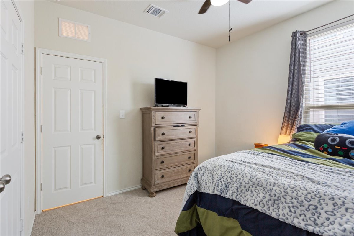 1500 Cliffbrake Way Georgetown, TX 78626 - Photo 25 of 35 Bedroom with light carpet and a ceiling fan