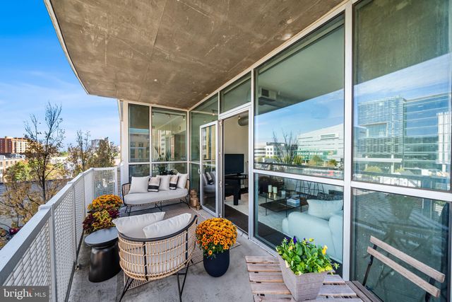 a balcony with chairs and table