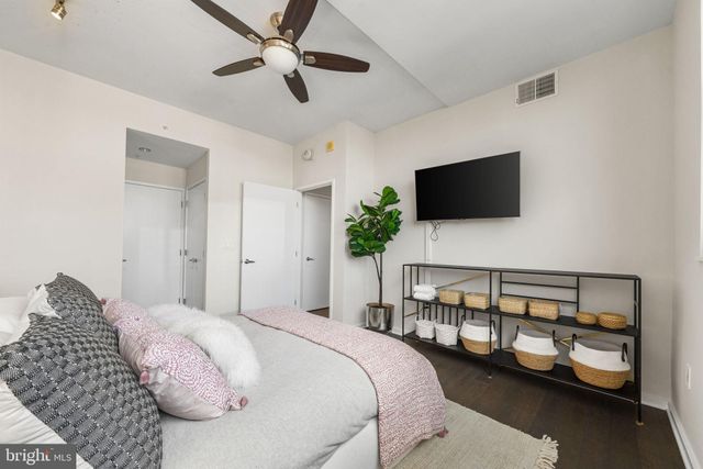 a bedroom with a bed and a flat screen tv