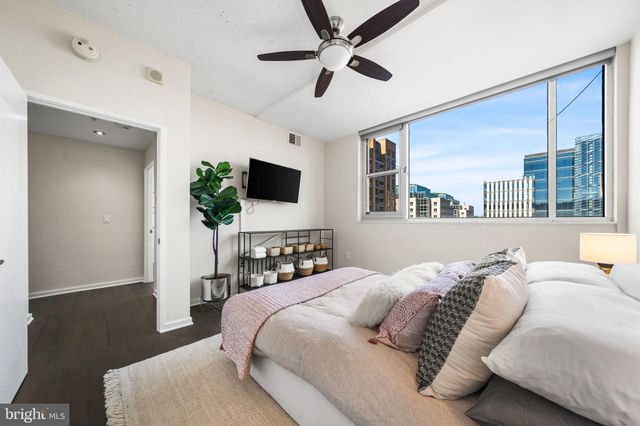 a bedroom with a bed window and a flat screen tv