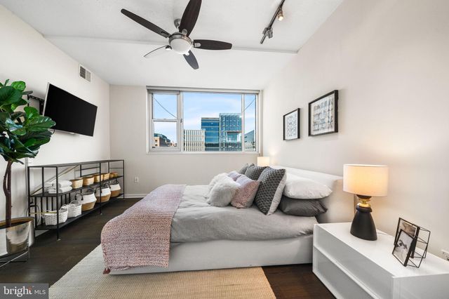 a bedroom with a bed and a flat screen tv