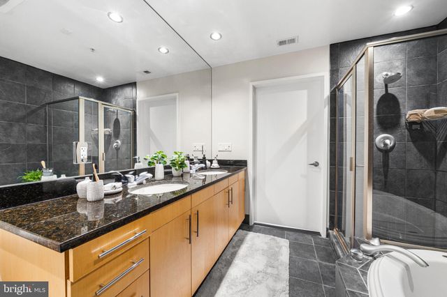 a spacious bathroom with sinks mirror and shower
