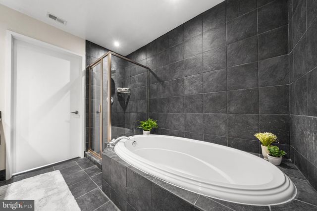a white bath tub sitting in a bathroom