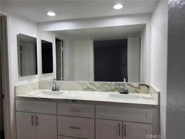 a bathroom with a sink and a mirror