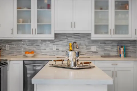 a kitchen with a sink and cabinets