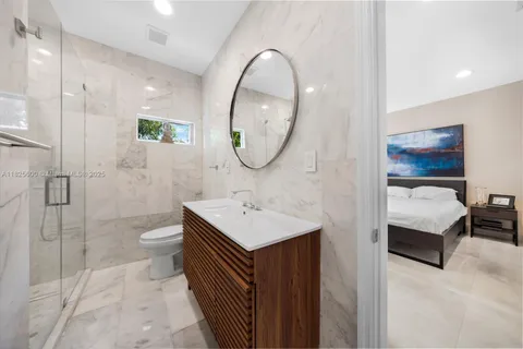 a bathroom with a sink toilet and a mirror