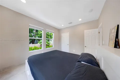 a living room with a bed furniture and a window