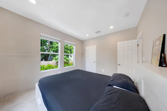 a living room with a bed furniture and a window
