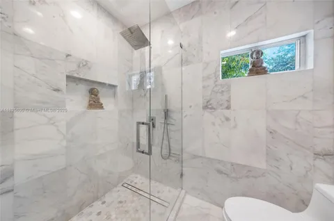 a bathroom with a shower and toilet