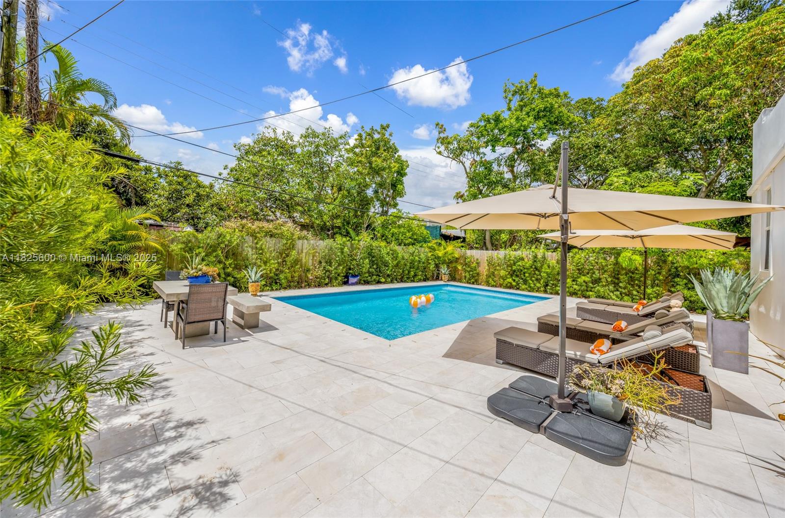 120 Northwest 49th Street Miami, FL 33127 - Photo 22 of 35 a view of a patio with a table and chairs under an umbrella
