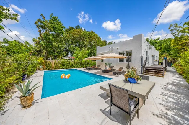 a view of a chairs and table in the patio