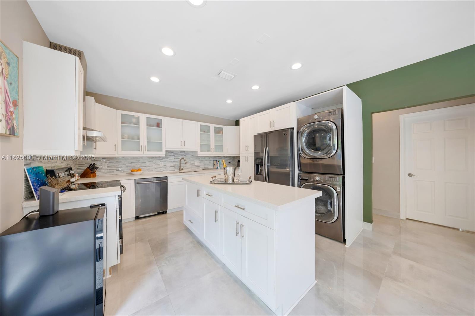 120 Northwest 49th Street Miami, FL 33127 - Photo 10 of 35 a large white kitchen with a stove a sink dishwasher and a refrigerator with wooden floor