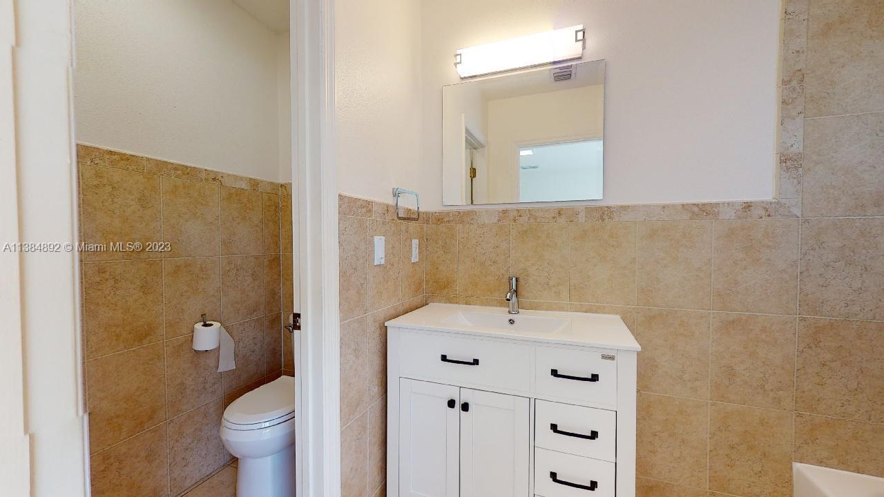 Kirkland Heights Miami, FL 33135 - Photo 10 of 11 a bathroom with a sink a toilet and shower