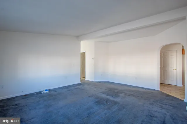 a room with furniture a flat screen tv and a window