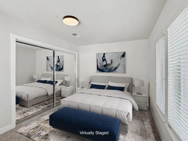 a bedroom with a bed and a painting on the wall