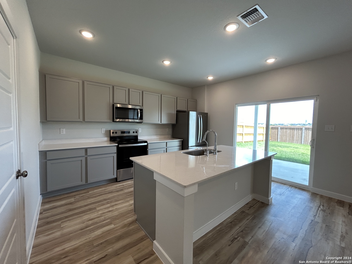 4305 Danforth Street New Braunfels, TX 78130 - Photo 11 of 31 a large kitchen with kitchen island a sink stainless steel appliances and cabinets