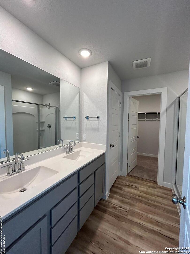 4305 Danforth Street New Braunfels, TX 78130 - Photo 18 of 31 a spacious bathroom with a double vanity sink and mirror