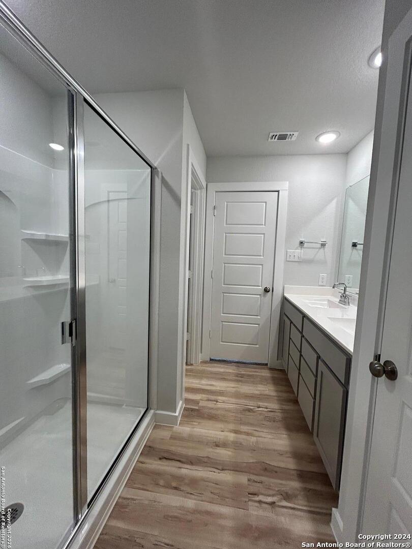 4305 Danforth Street New Braunfels, TX 78130 - Photo 19 of 31 a bathroom with double vanity and a shower