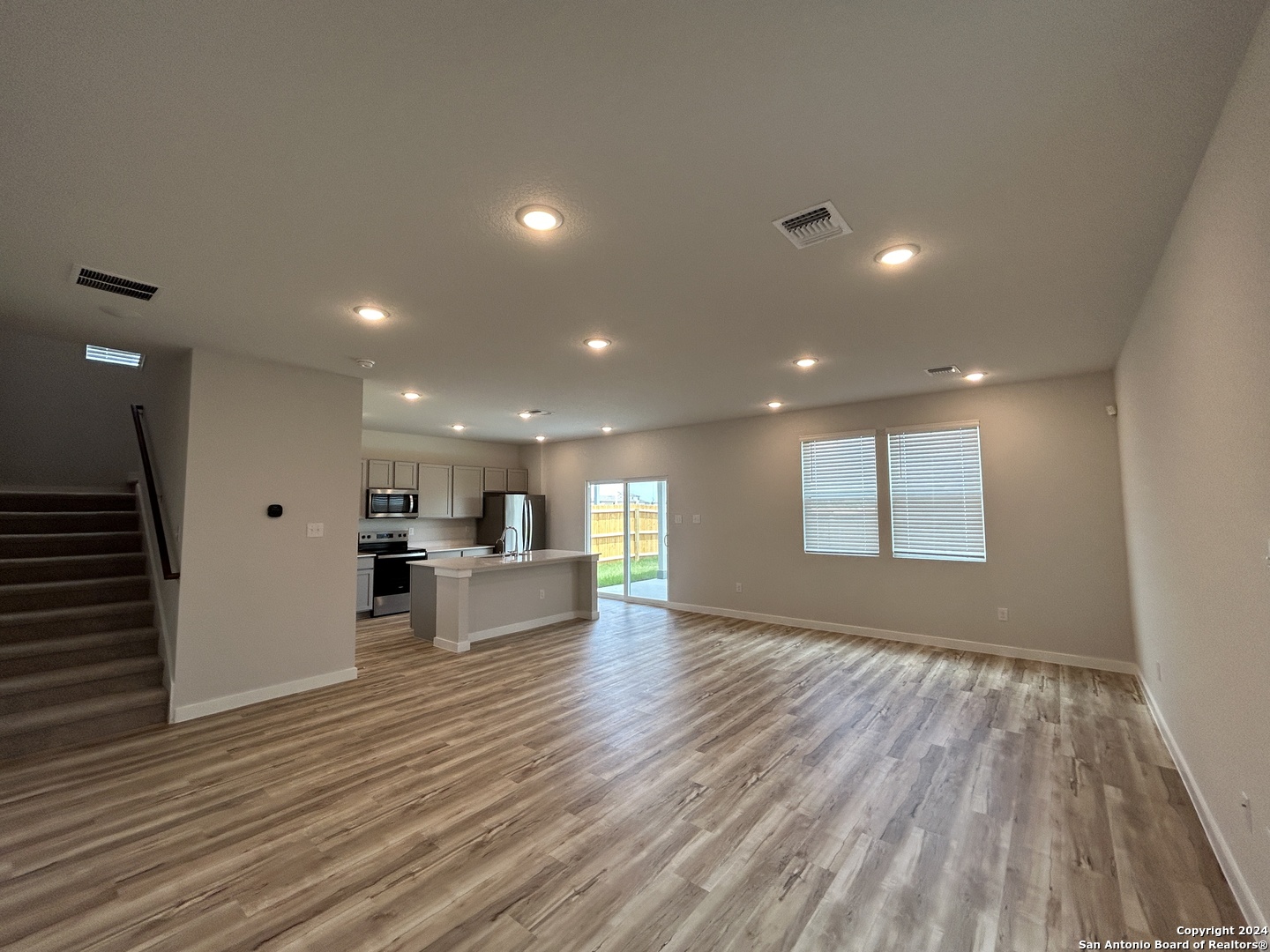 4305 Danforth Street New Braunfels, TX 78130 - Photo 2 of 31 a view of a big room with wooden floor and windows