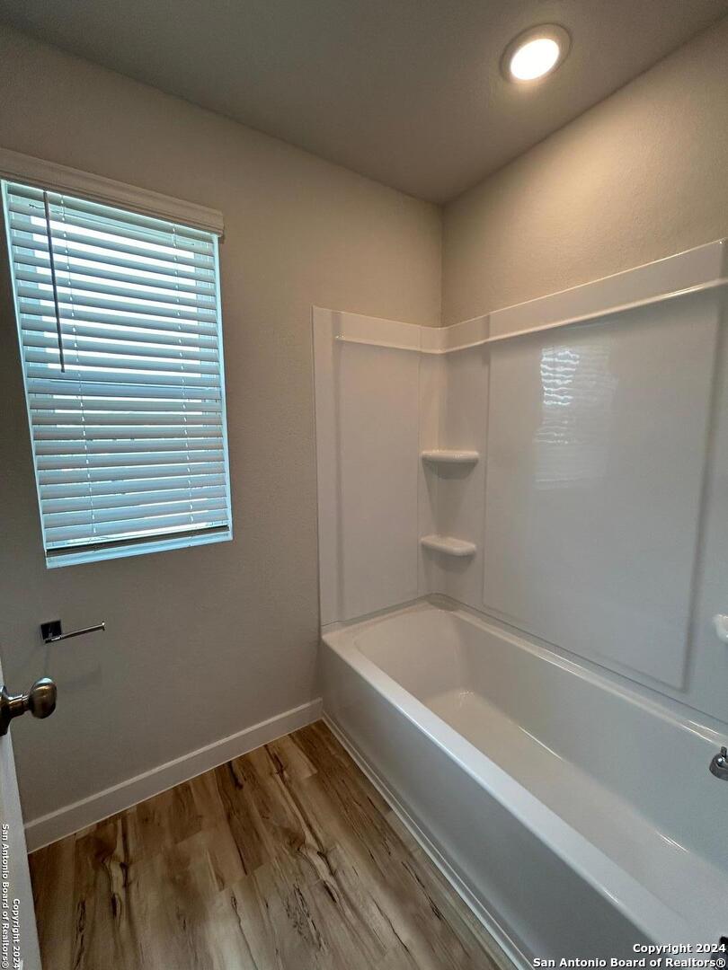 4305 Danforth Street New Braunfels, TX 78130 - Photo 28 of 31 a bathroom with a bathtub and a window