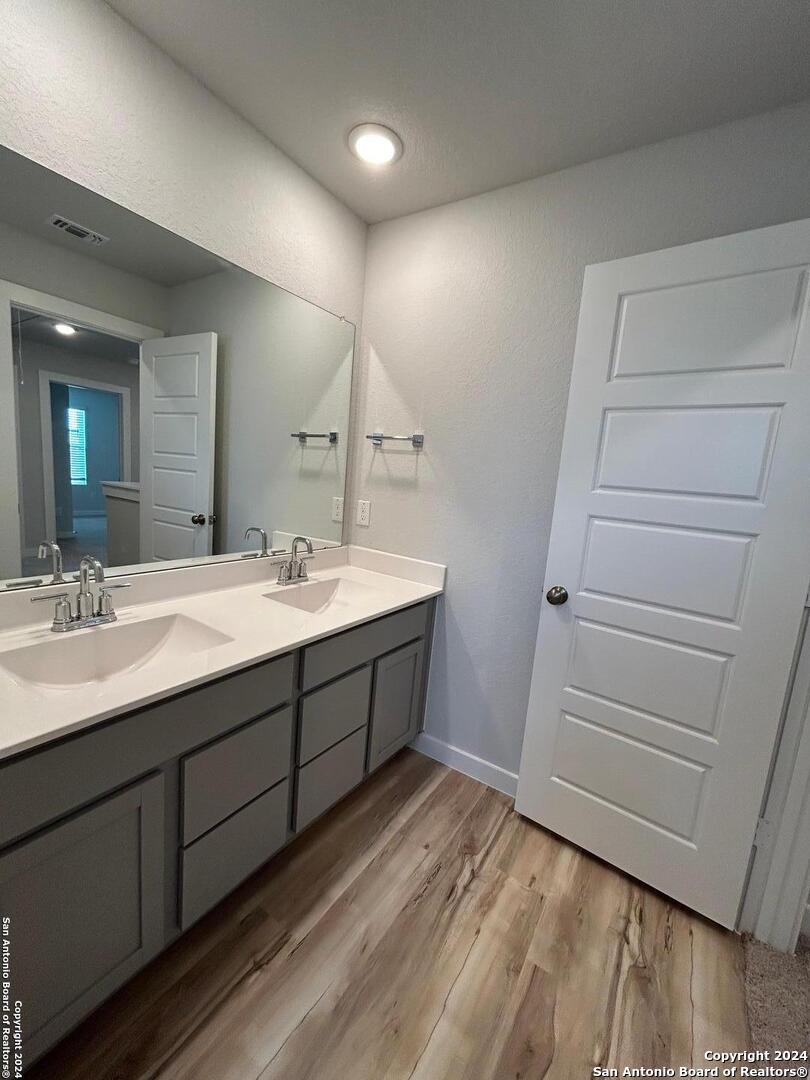 4305 Danforth Street New Braunfels, TX 78130 - Photo 29 of 31 a bathroom with a double vanity sink and a mirror