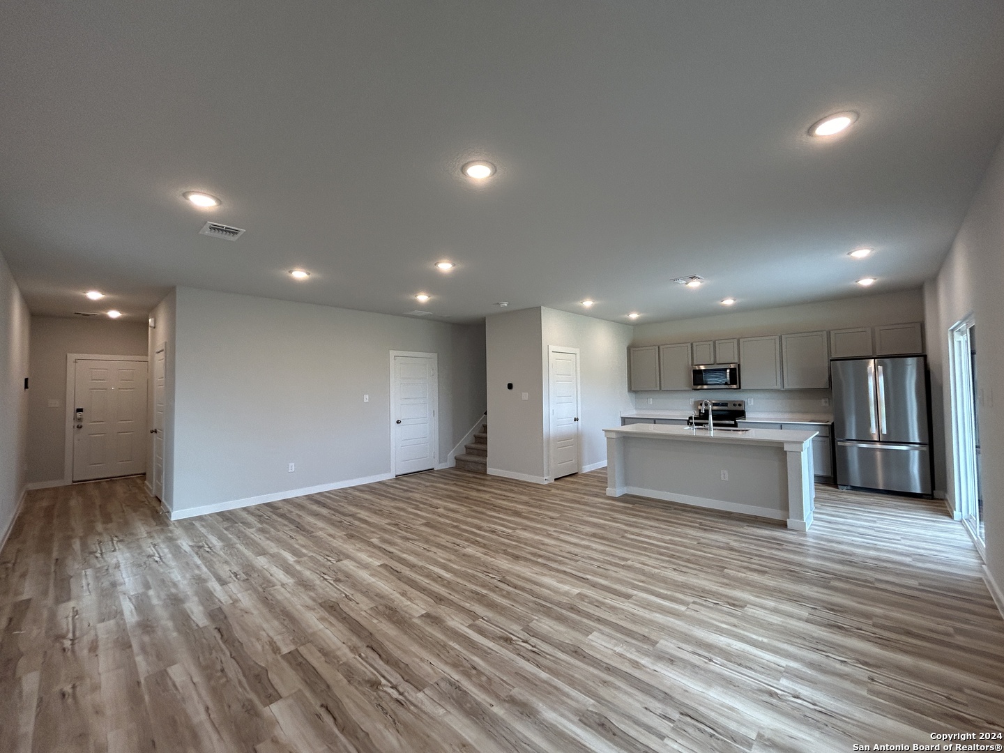 4305 Danforth Street New Braunfels, TX 78130 - Photo 4 of 31 a view of kitchen with kitchen island wooden floor center island and stainless steel appliances