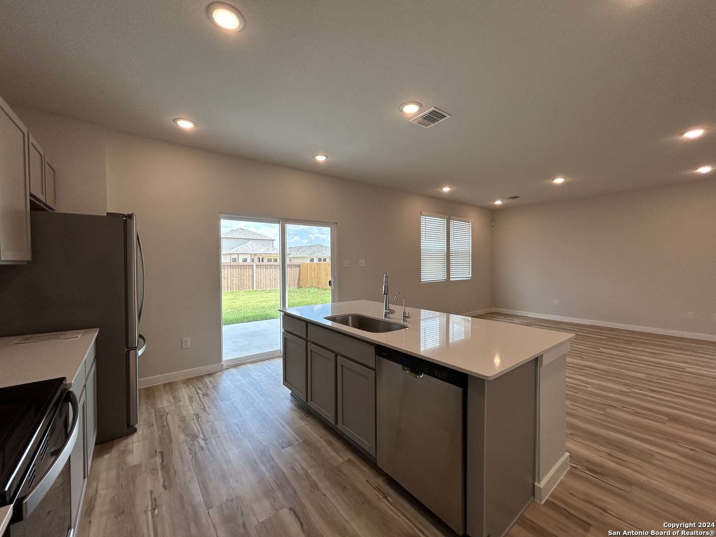 4305 Danforth Street New Braunfels, TX 78130 - Photo 10 of 31 a kitchen with stainless steel appliances granite countertop a sink stove and refrigerator