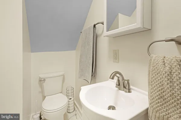 a bathroom with a sink a toilet and mirror